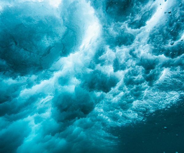 Abstract energy waves in dark blue and cyan colors